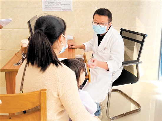 醫(yī)生正在接診呼吸道疾病患兒。