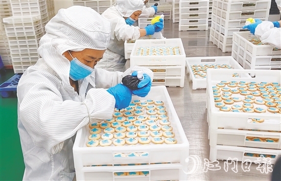 工人在餅干上裝裱卡通圖案。