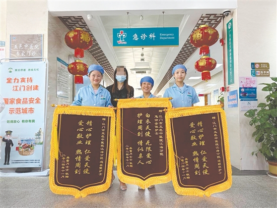 患者把三面錦旗贈(zèng)送給護(hù)士們，以表達(dá)感激之情。