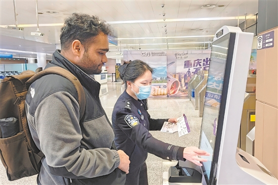 在重慶江北國(guó)際機(jī)場(chǎng)，重慶出入境邊防檢查總站民警幫助入境的新加坡旅客填寫入境信息。新華社發(fā)